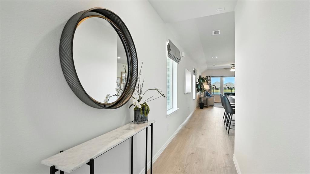 9820 Amalgam Street Aubrey, TX 76227 - Photo 24 of 40 a view of a livingroom with furniture and a floor to ceiling window