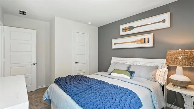 a bedroom with a bed and a dresser