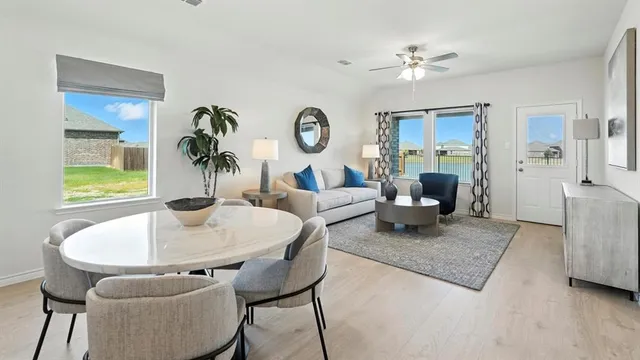 a living room with furniture a chandelier and a table