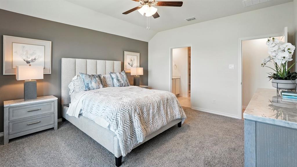 9820 Amalgam Street Aubrey, TX 76227 - Photo 31 of 40 a bed room with a bed and a chandelier