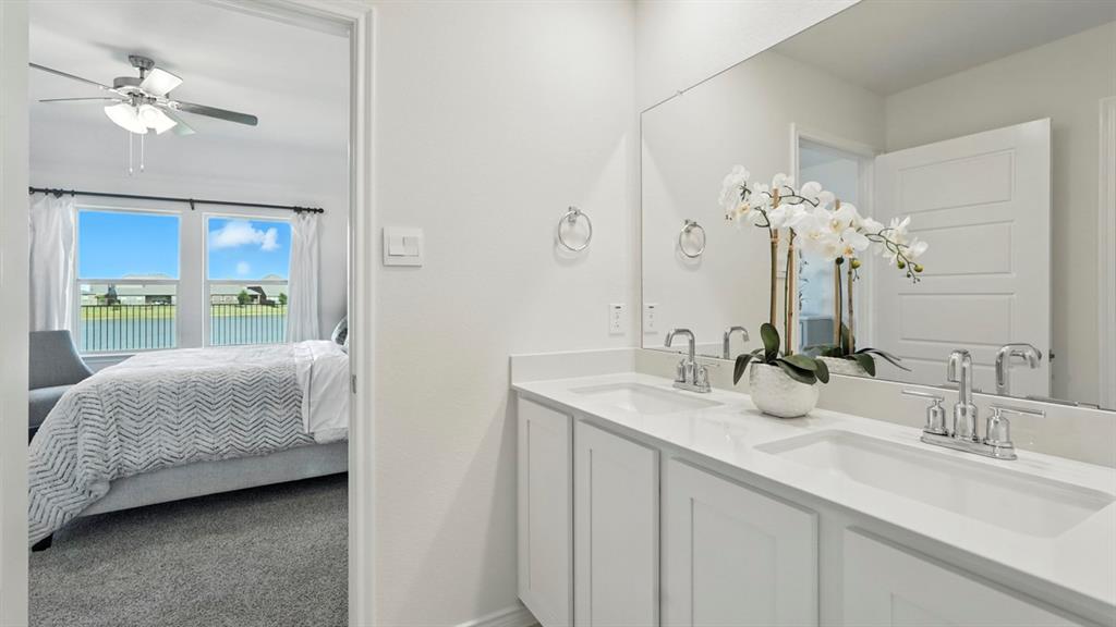 9820 Amalgam Street Aubrey, TX 76227 - Photo 40 of 40 a en suite bathroom with a double vanity sink and a mirror