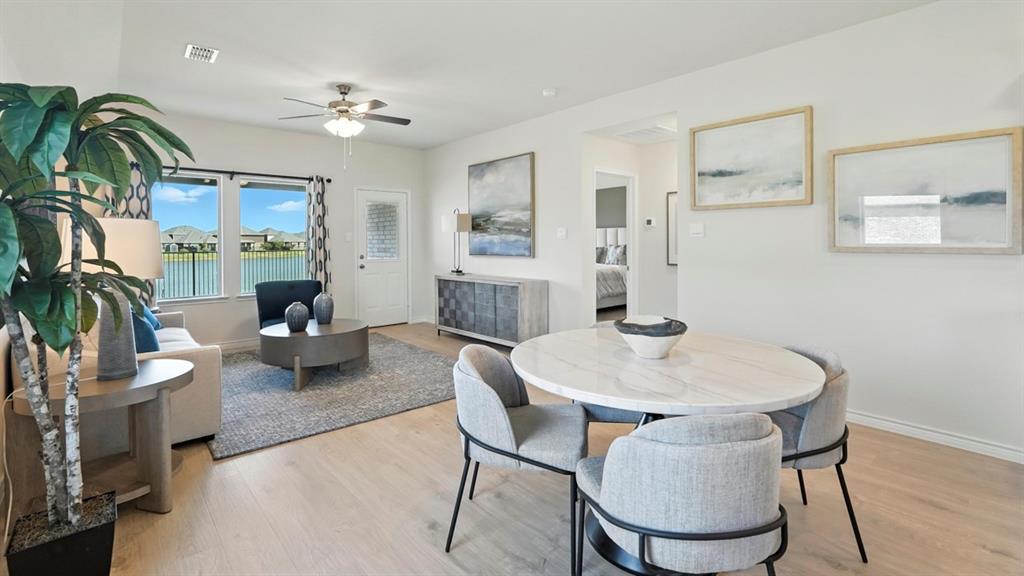 9820 Amalgam Street Aubrey, TX 76227 - Photo 4 of 40 a living room with furniture and a fireplace