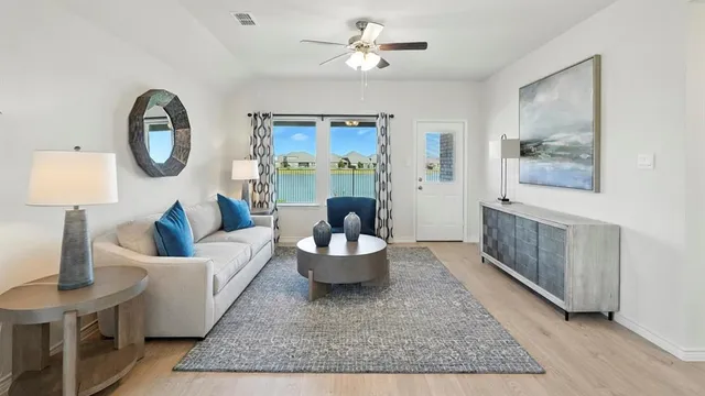 a living room with furniture a rug and a window