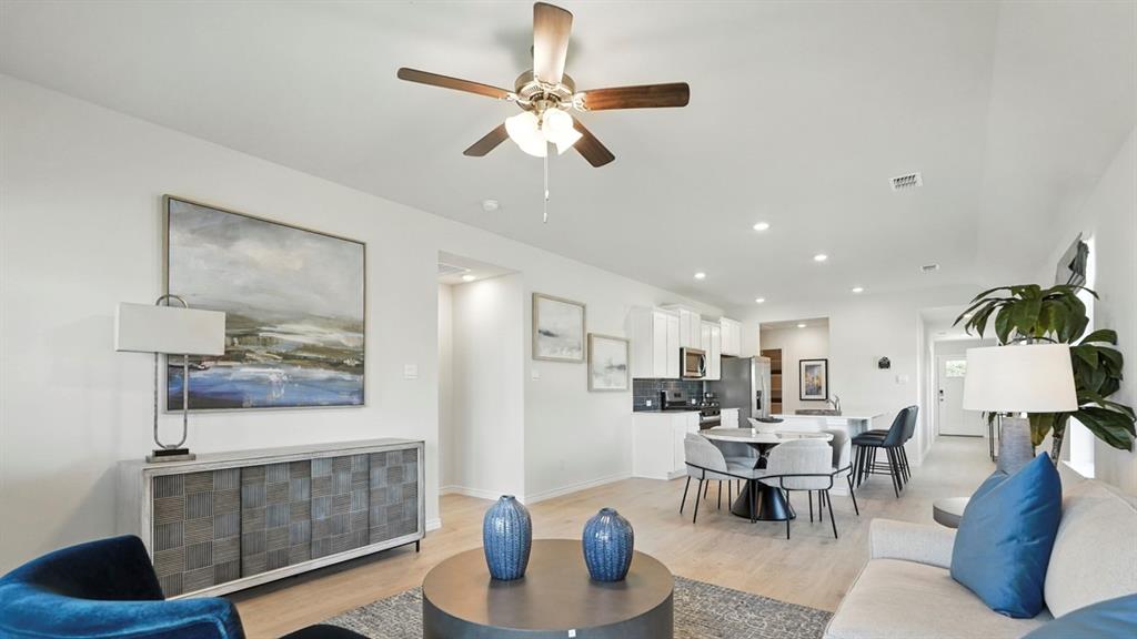 9820 Amalgam Street Aubrey, TX 76227 - Photo 9 of 40 a living room with furniture and a chandelier
