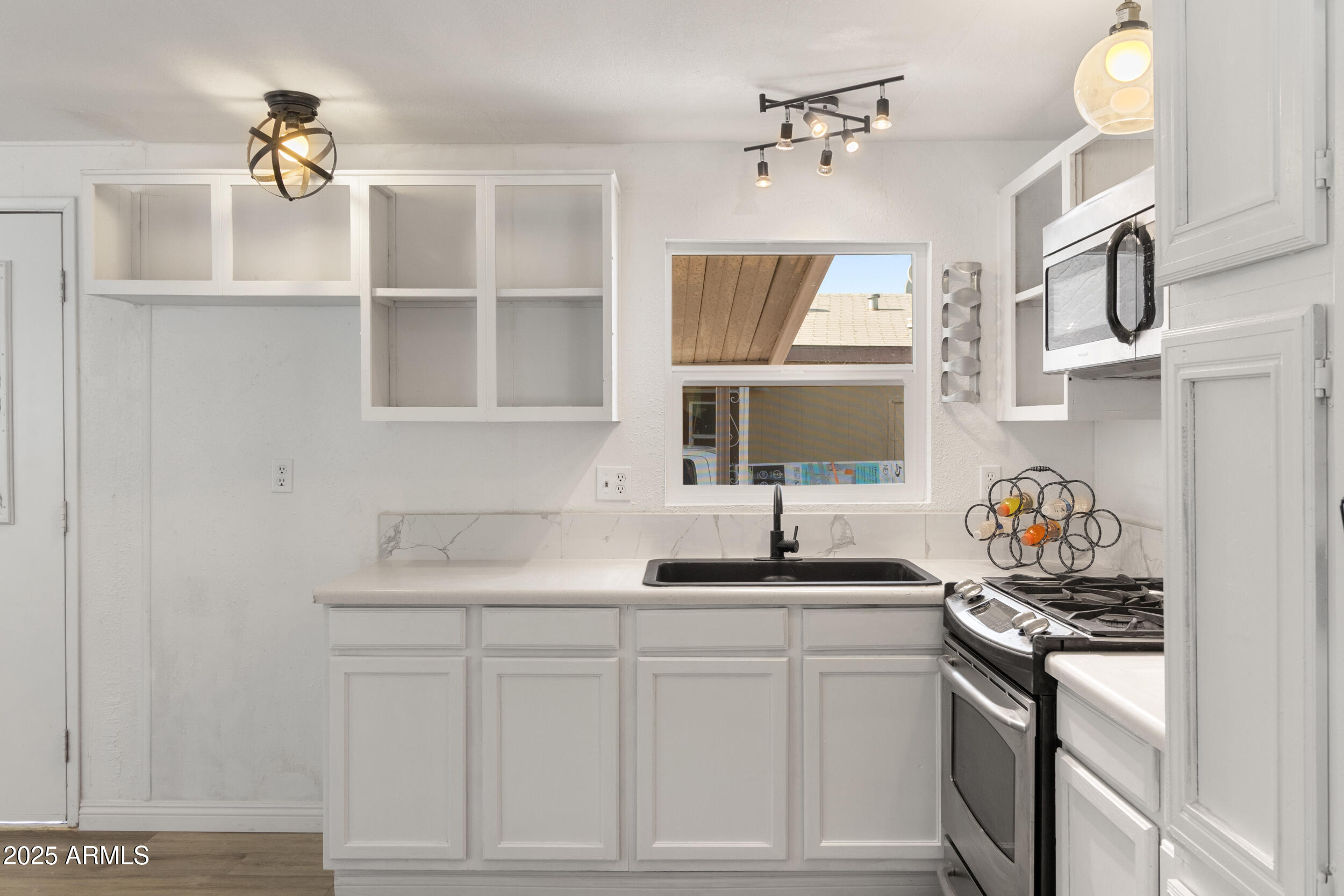400 West Baseline Road, Unit 100 Tempe, AZ 85283 - Photo 11 of 46 a kitchen with stainless steel appliances granite countertop a sink and a stove with white countertops