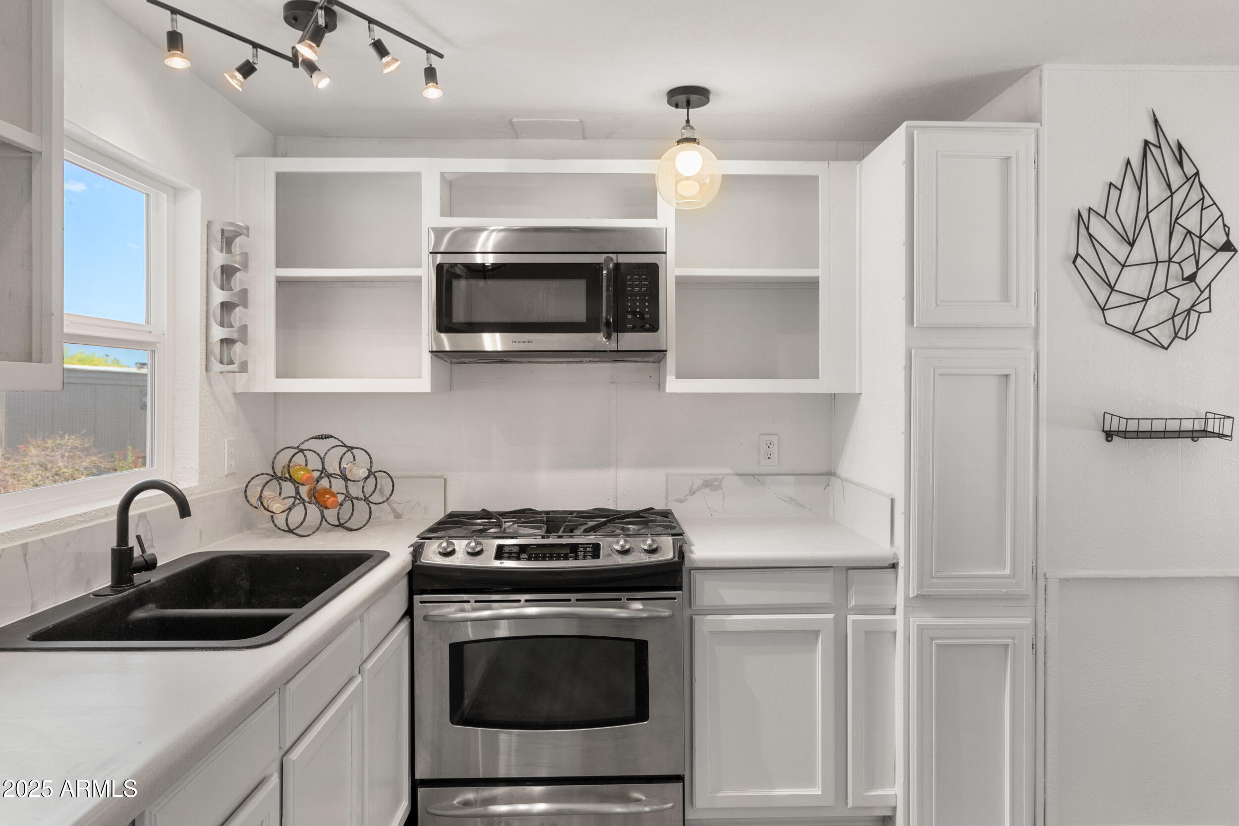 400 West Baseline Road, Unit 100 Tempe, AZ 85283 - Photo 12 of 46 a kitchen with stainless steel appliances granite countertop a sink stove and microwave
