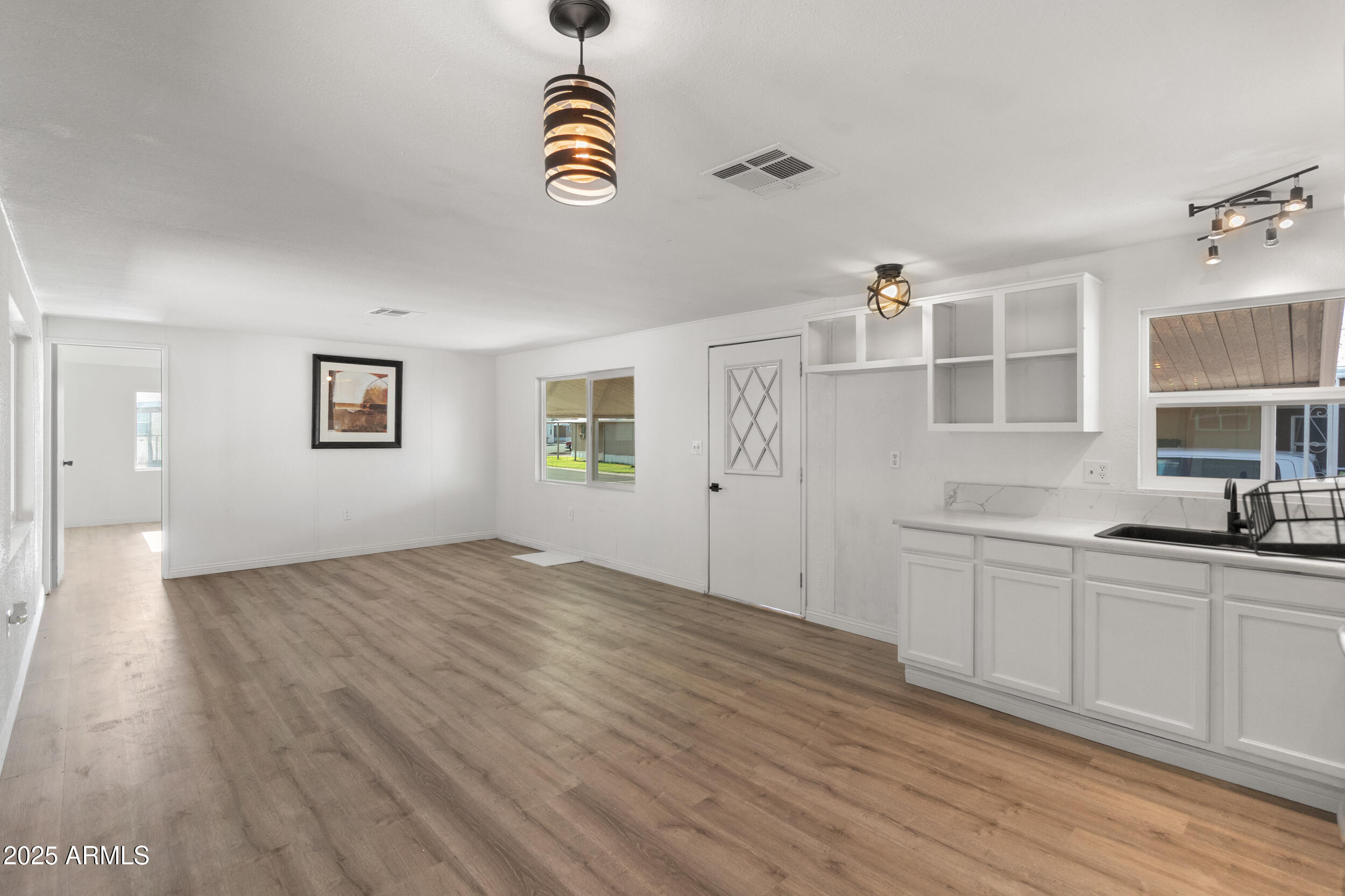 400 West Baseline Road, Unit 100 Tempe, AZ 85283 - Photo 14 of 46 a view of empty room with wooden floor and window