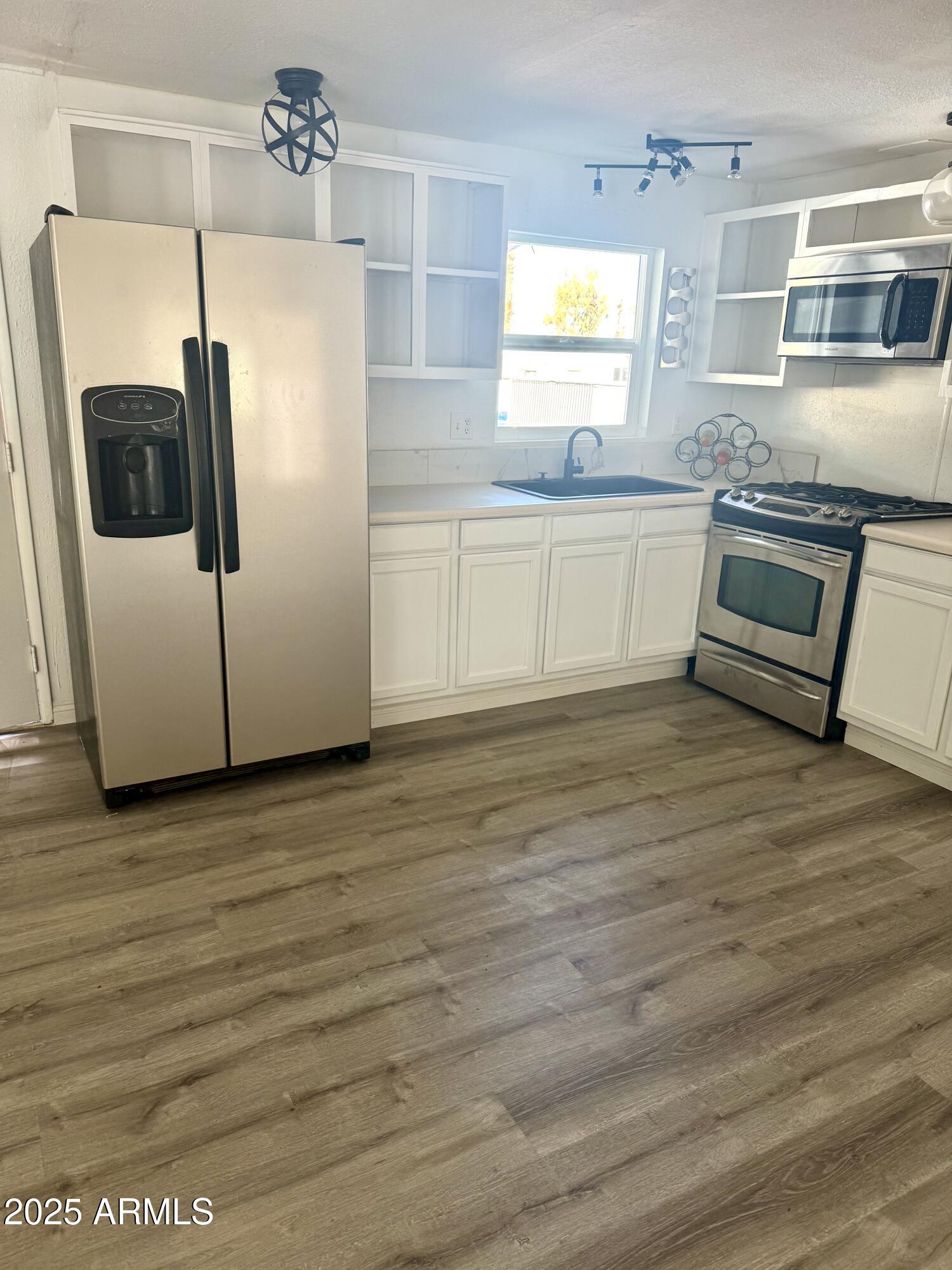 400 West Baseline Road, Unit 100 Tempe, AZ 85283 - Photo 2 of 46 a kitchen with stainless steel appliances granite countertop a refrigerator and a stove