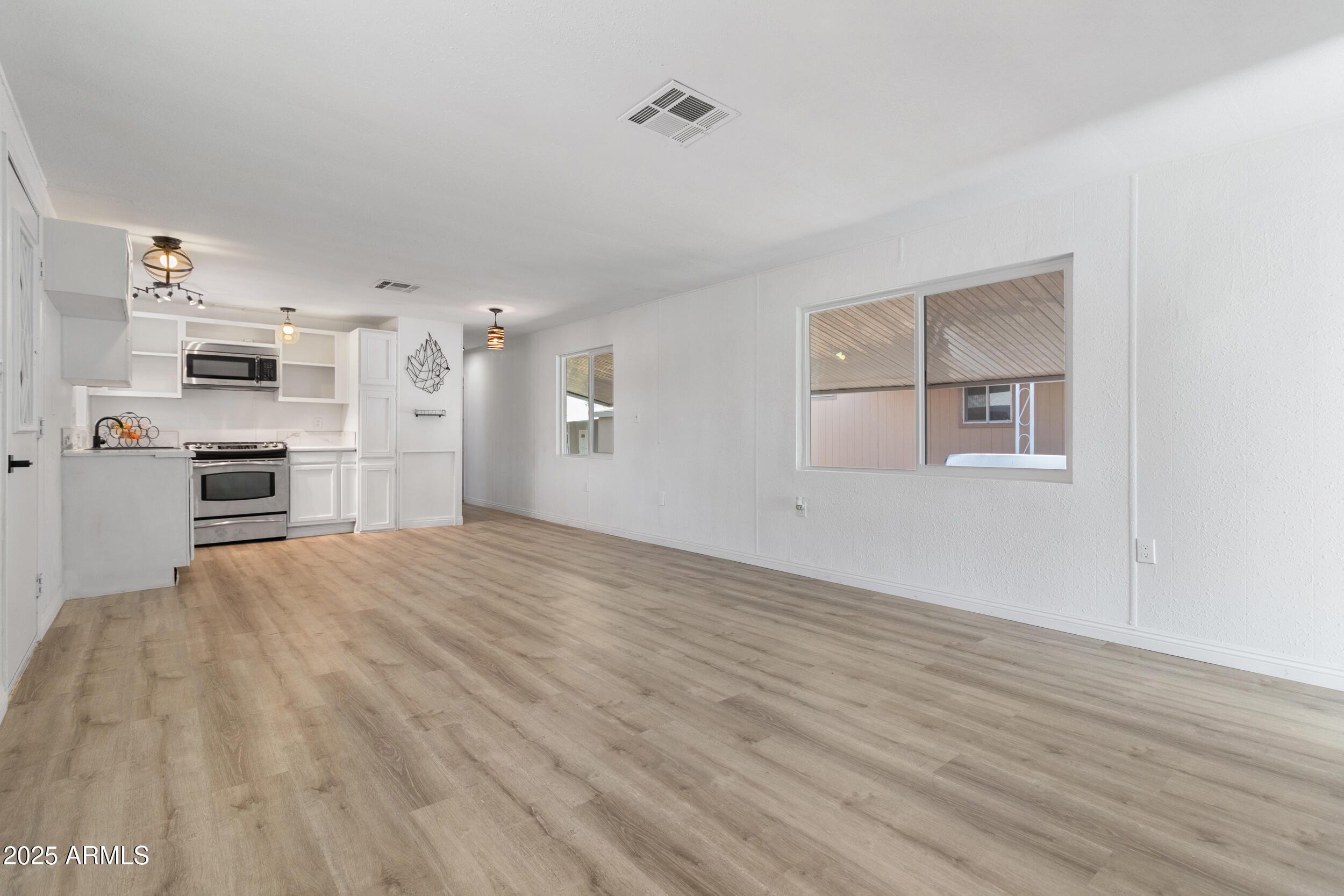 400 West Baseline Road, Unit 100 Tempe, AZ 85283 - Photo 7 of 46 an empty room with kitchen appliances and a windows