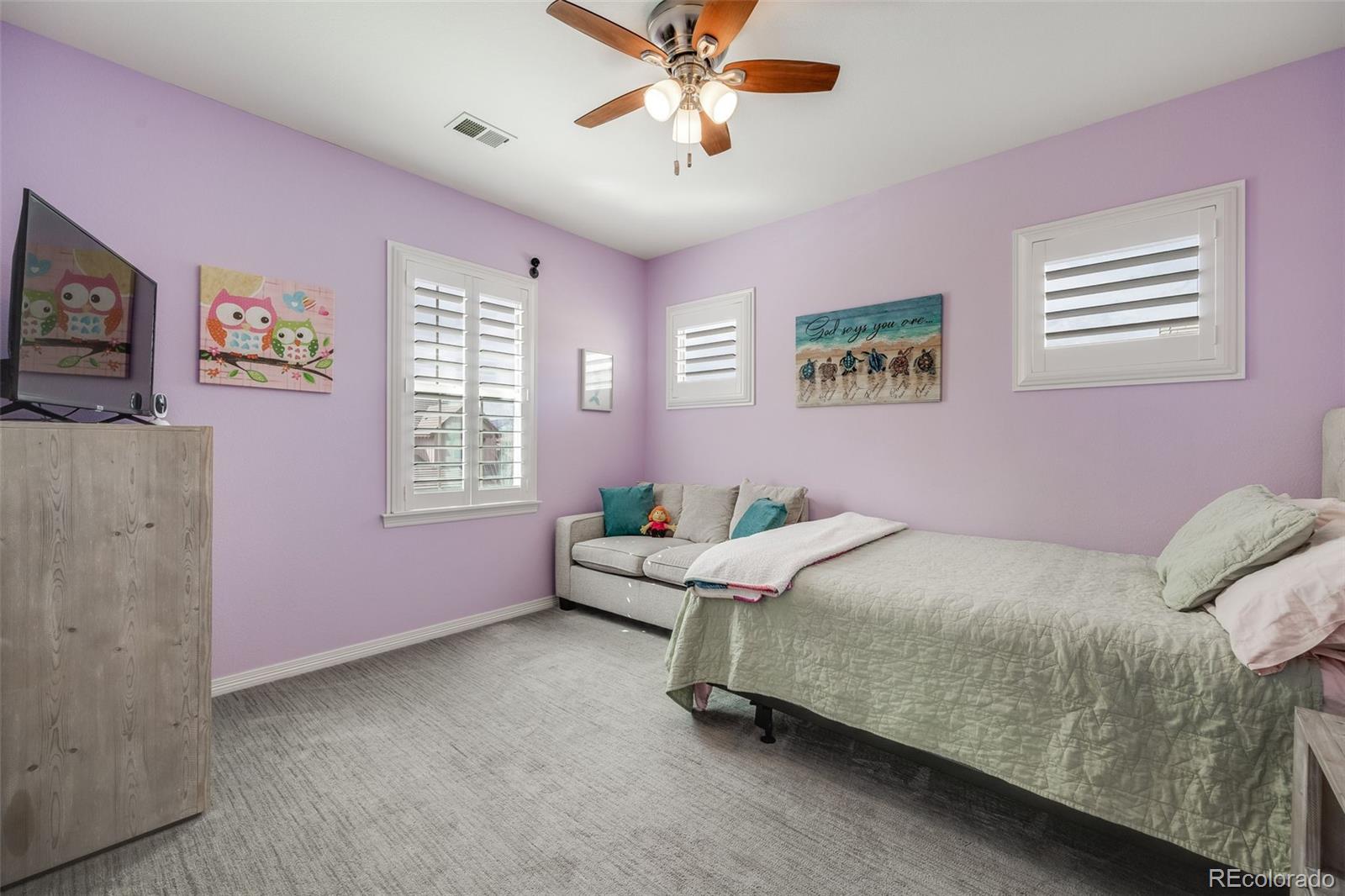 10702 Sundial Rim Road Highlands Ranch, CO 80126 - Photo 24 of 49 a bed room with a bed and a window