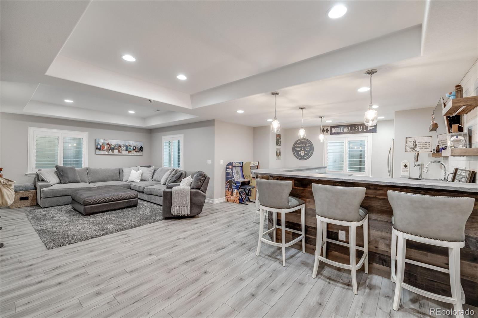 10702 Sundial Rim Road Highlands Ranch, CO 80126 - Photo 32 of 49 a living room with furniture and a wooden floor