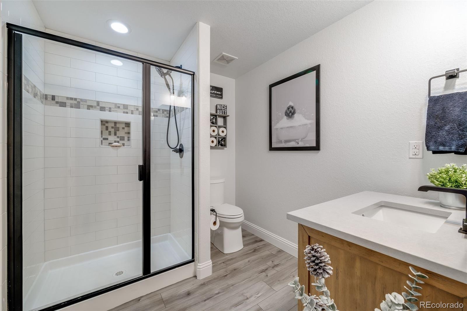 10702 Sundial Rim Road Highlands Ranch, CO 80126 - Photo 35 of 49 a bathroom with a granite countertop sink toilet and shower