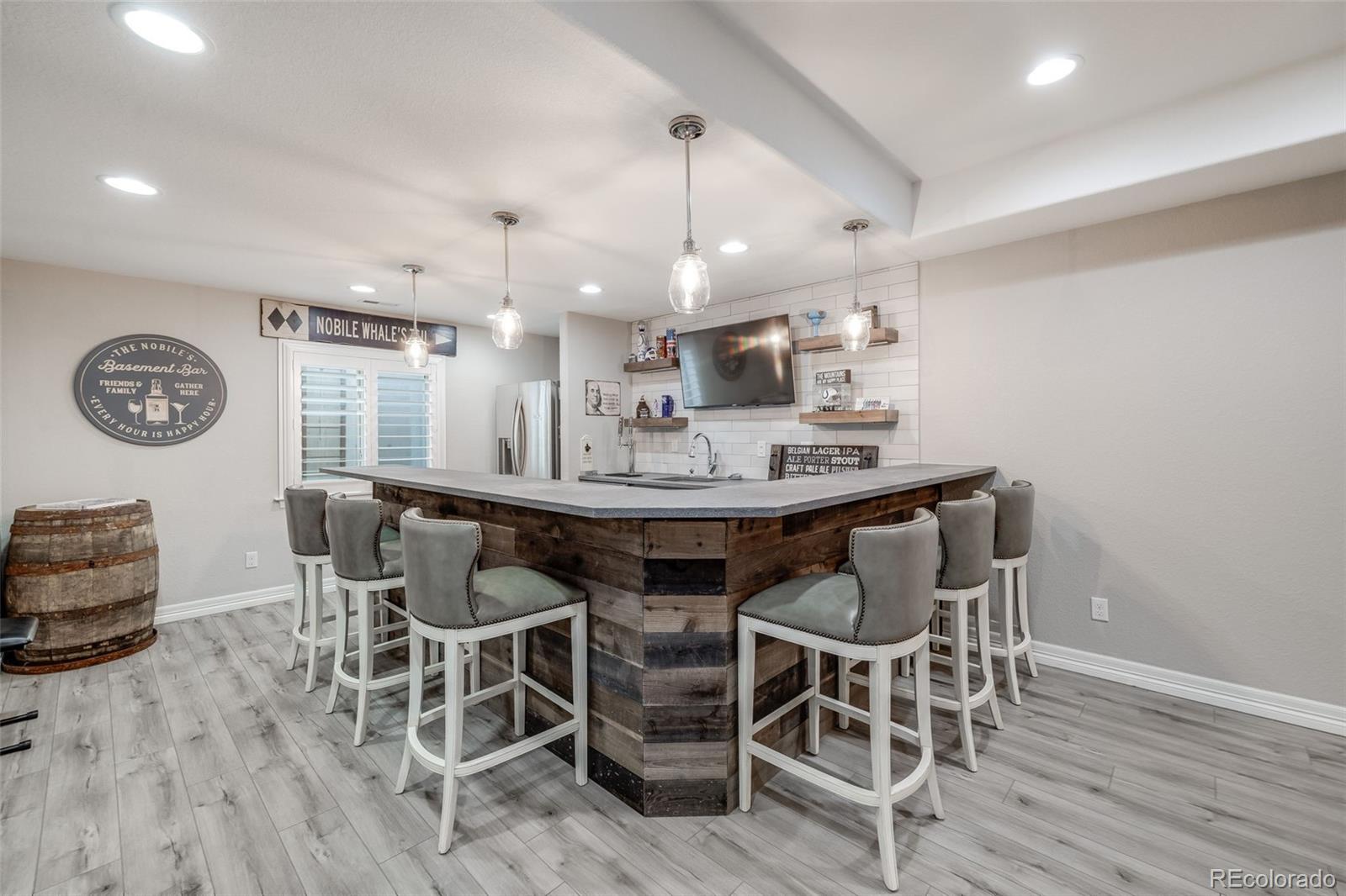 10702 Sundial Rim Road Highlands Ranch, CO 80126 - Photo 36 of 49 a dining room with furniture and wooden floor