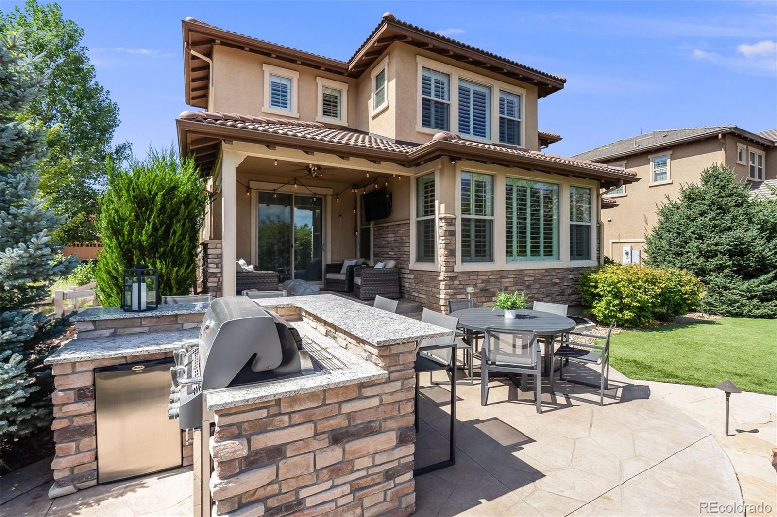 10702 Sundial Rim Road Highlands Ranch, CO 80126 - Photo 40 of 49 a view of a house with backyard sitting area and garden