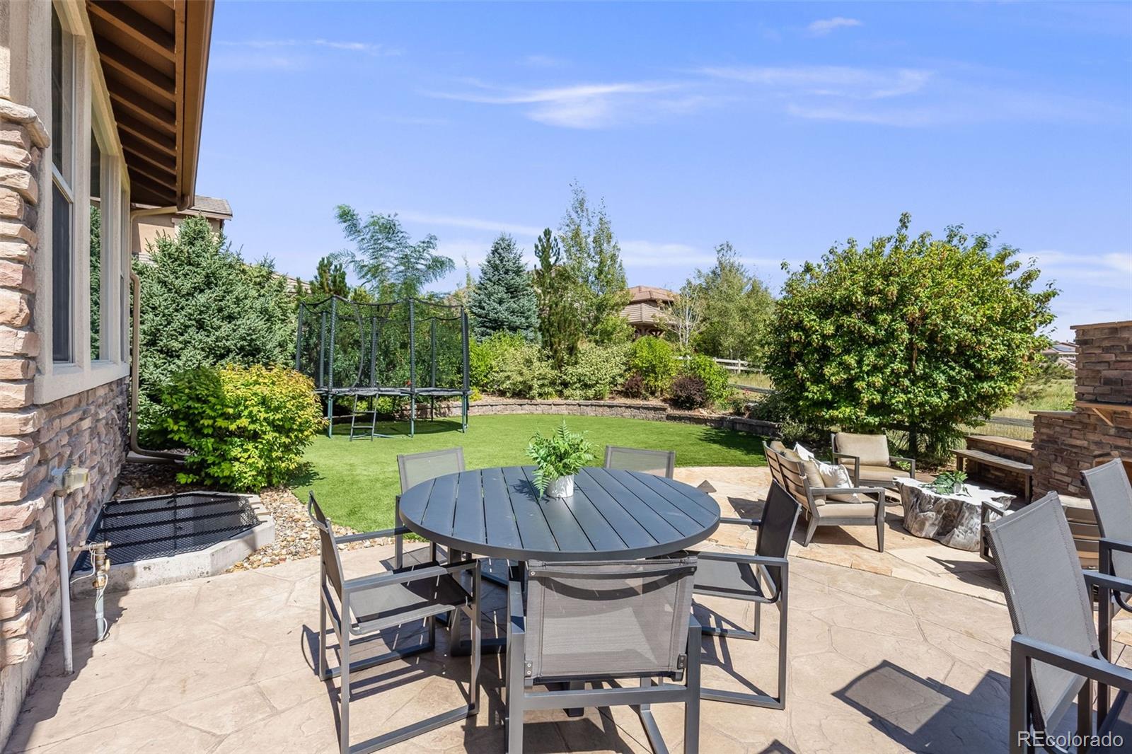 10702 Sundial Rim Road Highlands Ranch, CO 80126 - Photo 42 of 49 a view of a chairs and table in patio