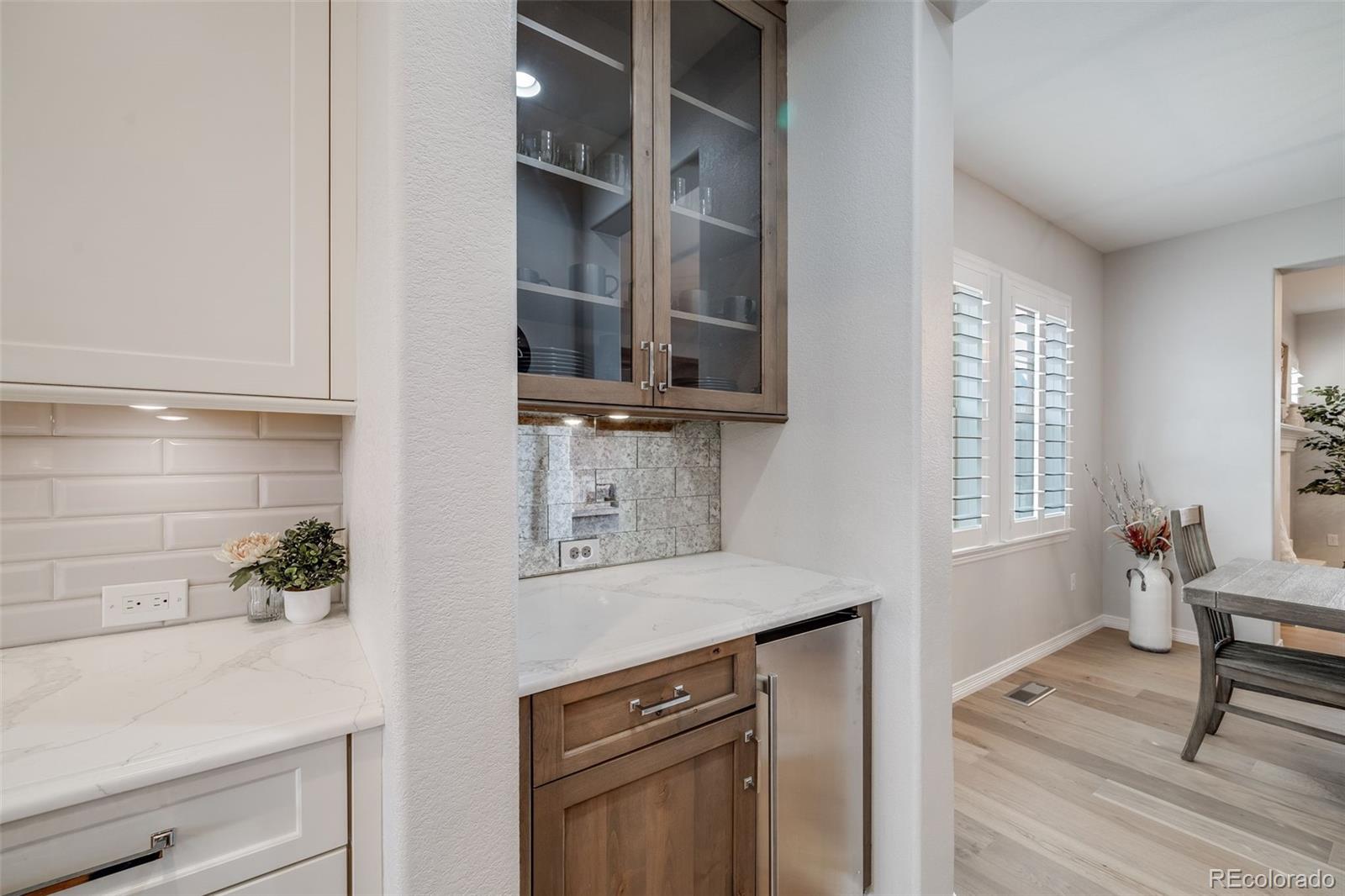 10702 Sundial Rim Road Highlands Ranch, CO 80126 - Photo 7 of 49 a kitchen with cabinets and window