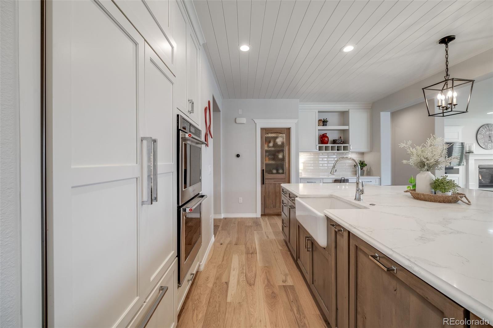 10702 Sundial Rim Road Highlands Ranch, CO 80126 - Photo 9 of 49 a view of a kitchen with a sink and wooden floor
