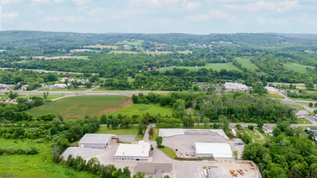 an aerial view of a house with a garden and lake view