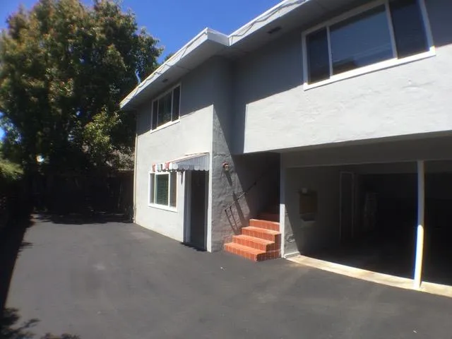 a backyard of a house with wooden fence