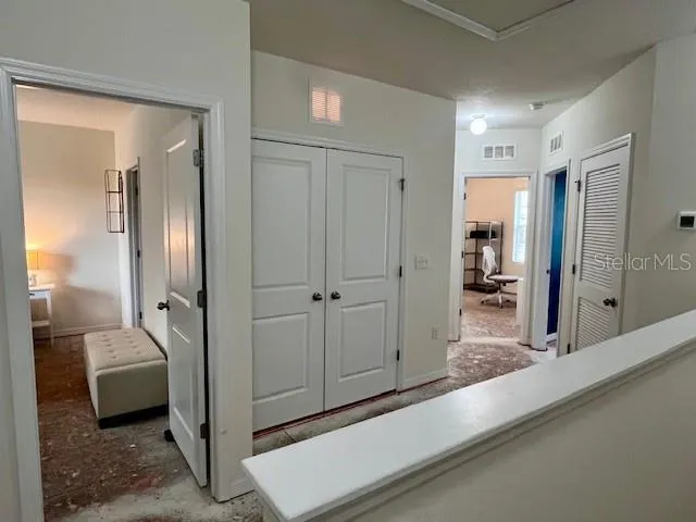 a view of a hallway with a living room and a bathroom