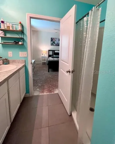 a bathroom with a shower and a sink