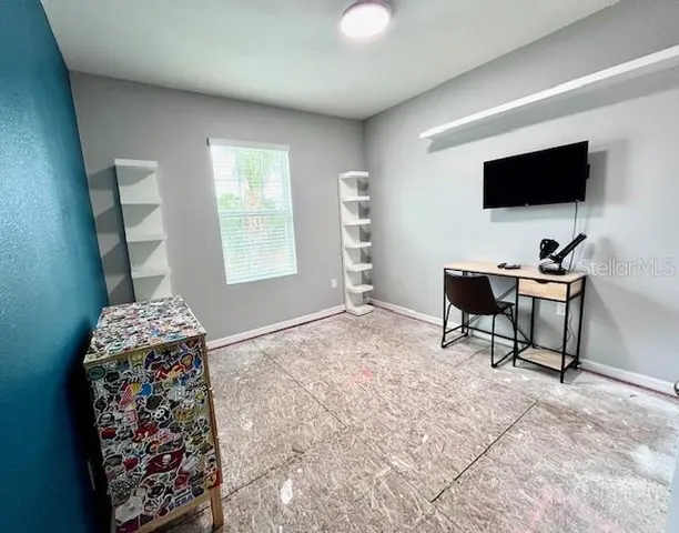 a workspace with furniture and window