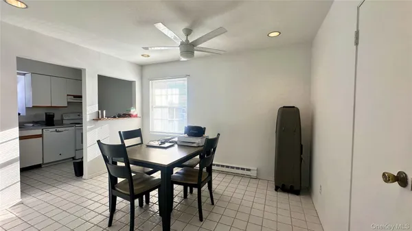 a dining room with furniture and window