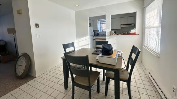 a dining room with furniture and window