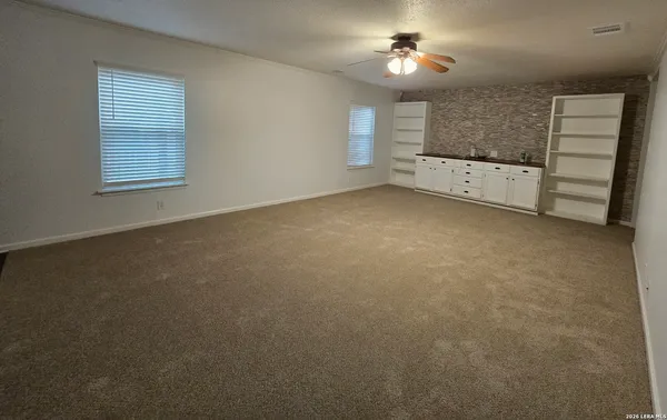 an empty room with a empty space and windows