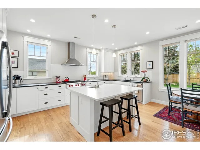 a kitchen with stainless steel appliances kitchen island granite countertop a sink and cabinets