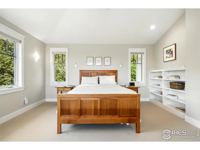a bedroom with a bed and a view of kitchen
