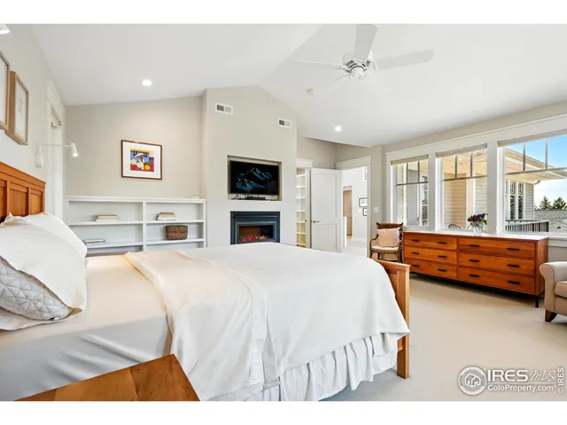 a spacious bedroom with a large bed and a tv