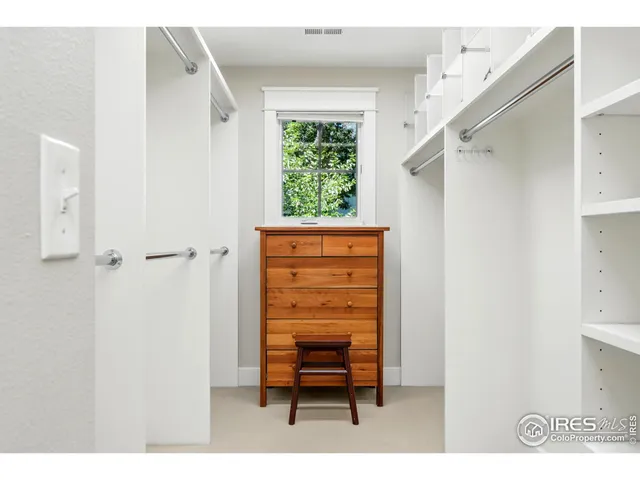 a hallway with a chair and a window
