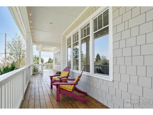 a balcony with wooden floor and furniture