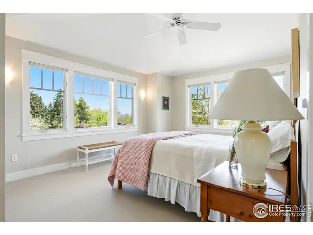 a bedroom with a bed lamps and window