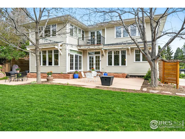 a front view of a house with a yard table and chairs