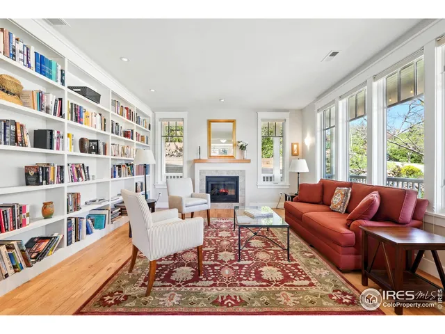 a living room with furniture and a book shelf
