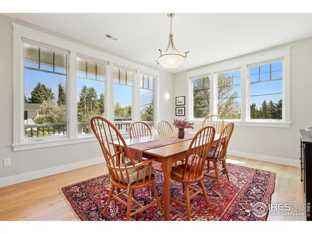 a view of a dining room with furniture wooden floor and chandelier