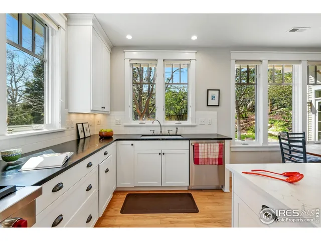 a open kitchen with granite countertop a sink window and cabinets