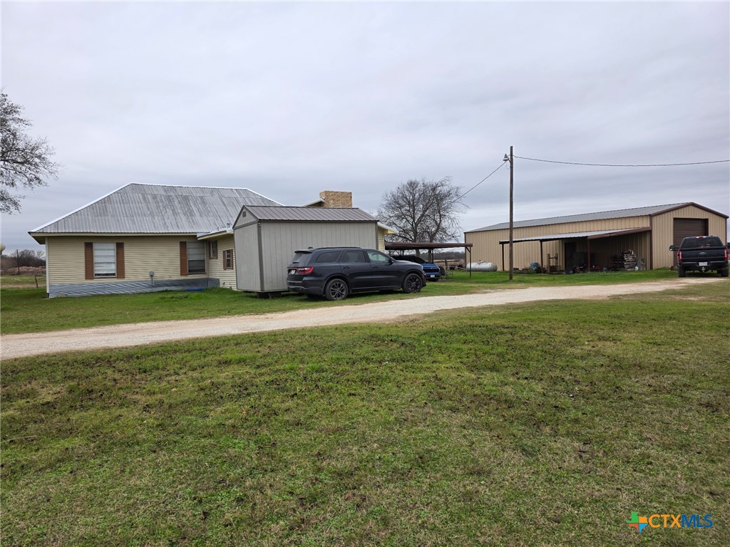 140 County Road 147 Groesbeck, TX 76642 - Photo 2 of 2 a view of a house with a big yard and large trees
