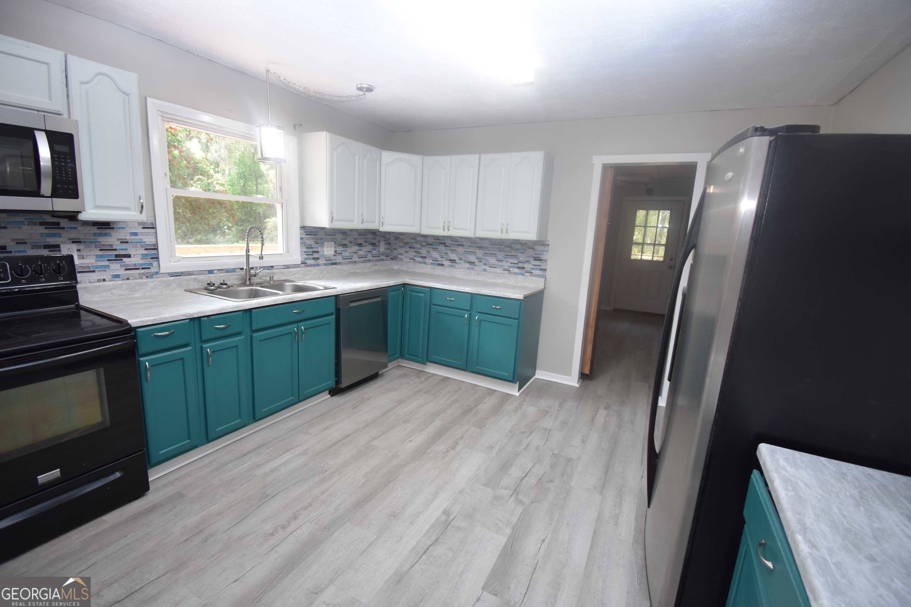 2353 Greenville Road Kingsland, GA 31548 - Photo 2 of 21 a kitchen with stainless steel appliances granite countertop a sink stove and refrigerator