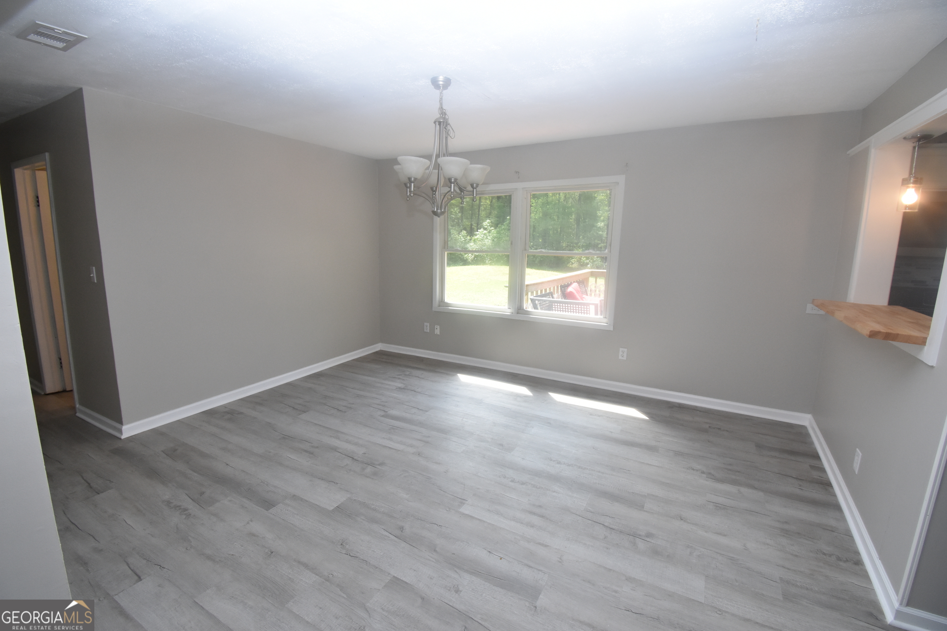 2353 Greenville Road Kingsland, GA 31548 - Photo 7 of 21 an empty room with wooden floor and windows