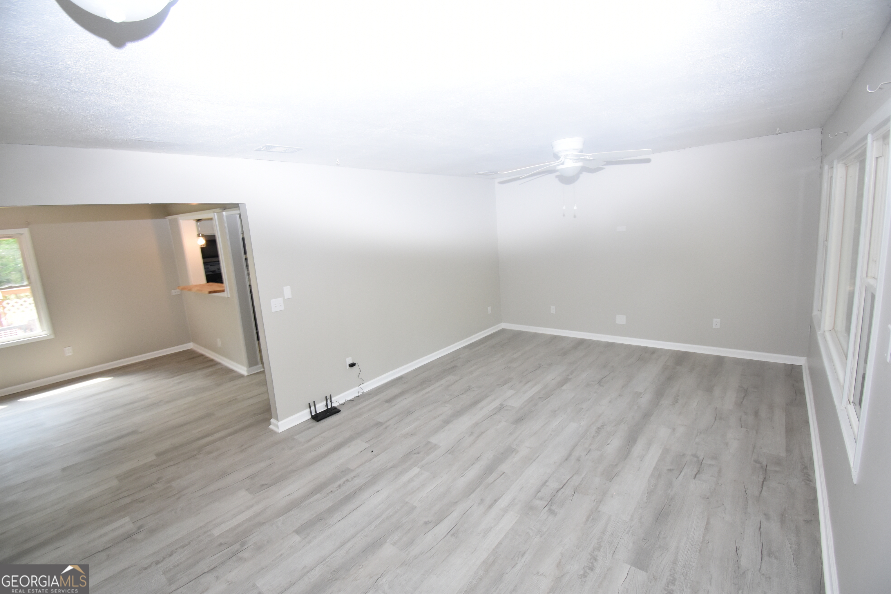 2353 Greenville Road Kingsland, GA 31548 - Photo 9 of 21 an empty room with wooden floor and windows
