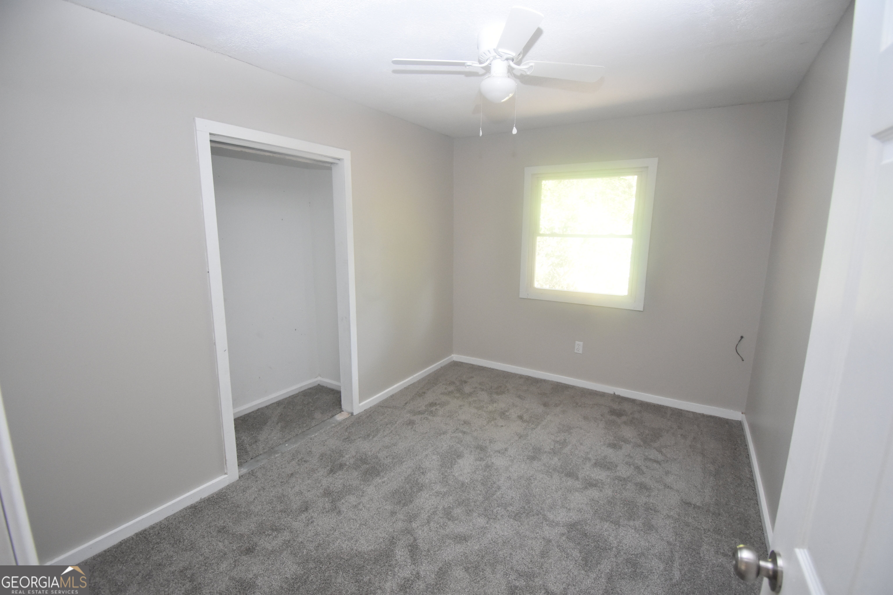 2353 Greenville Road Kingsland, GA 31548 - Photo 10 of 21 an empty room with a window and ceiling fan