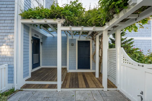 a view of a dining room with furniture large windows and wooden floor