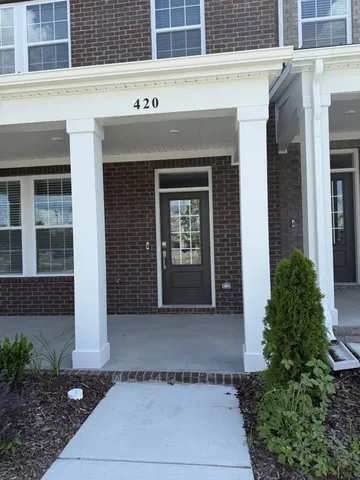 a front view of a building with potted plants