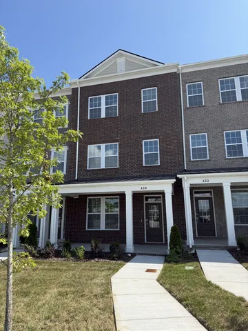 a front view of a house with yard and porch