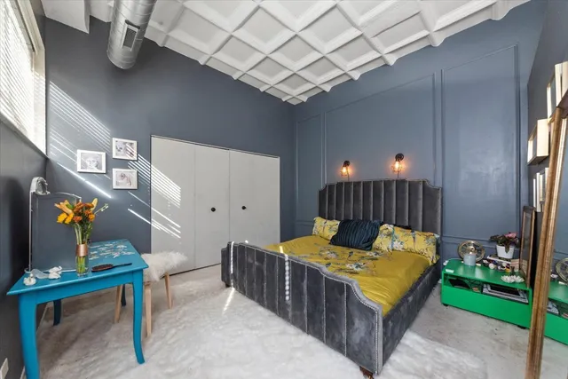 a bedroom with bed and a chandelier