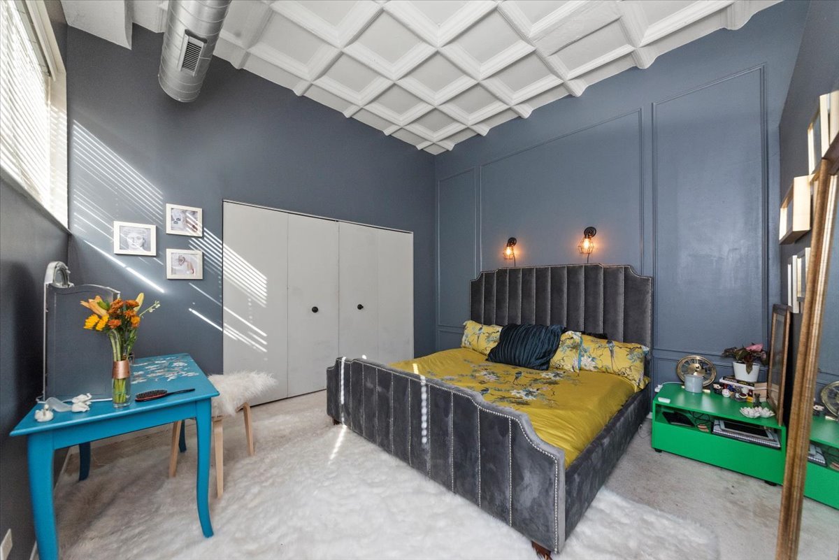 1307 South Wabash Avenue, Unit 605 Chicago, IL 60605 - Photo 7 of 11 a bedroom with bed and a chandelier