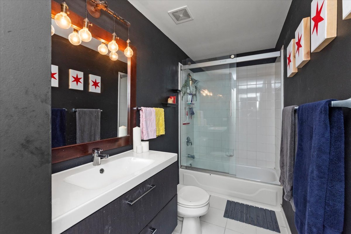 1307 South Wabash Avenue, Unit 605 Chicago, IL 60605 - Photo 9 of 11 a bathroom with a sink a toilet and shower